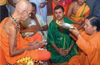 Uma Bharti offers pada pooja to Pejawar seer on Gurupurnima